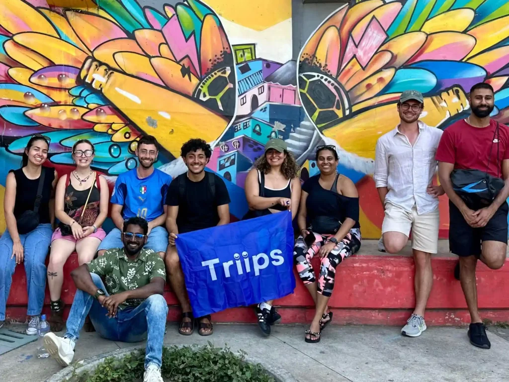 Triips team members with the Triips sign outdoors